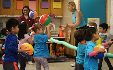 Michele in KID-FIT class with children and beach balls